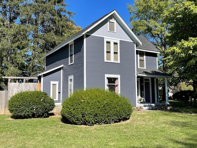 view of home's exterior featuring a shingled roof and covered porch