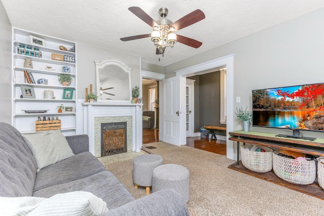141 E 5th Ave, Lancaster, OH 43130 - living room with ceiling fan, a fireplace with flush hearth, a textured ceiling, built in shelves, and wood finished floors