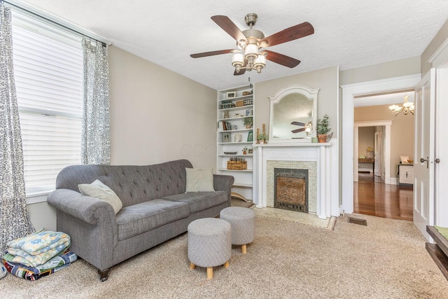 141 E 5th Ave, Lancaster, OH 43130 - living area featuring ceiling fan, a fireplace with flush hearth, carpet flooring, and a chandelier