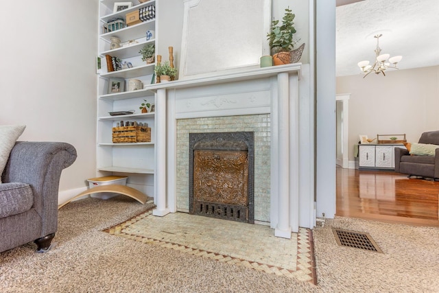 141 E 5th Ave, Lancaster, OH 43130 - living area featuring a chandelier, a fireplace, and carpet flooring