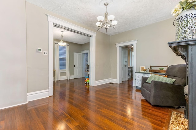141 E 5th Ave, Lancaster, OH 43130 - sitting room with wood finished floors, a chandelier, baseboards, and a textured ceiling