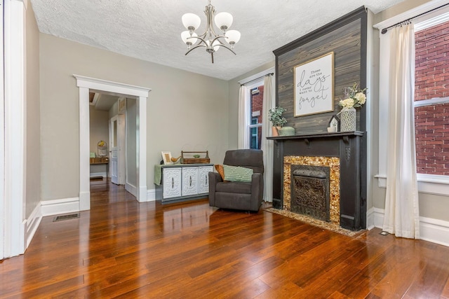 141 E 5th Ave, Lancaster, OH 43130 - sitting room with hardwood / wood-style floors, a fireplace, a chandelier, baseboards, and a textured ceiling
