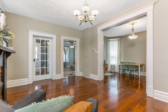 141 E 5th Ave, Lancaster, OH 43130 - living room with a chandelier, wood finished floors, baseboards, and a textured ceiling