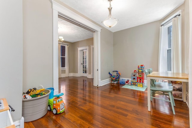 141 E 5th Ave, Lancaster, OH 43130 - game room with wood finished floors, baseboards, a textured ceiling, and a chandelier
