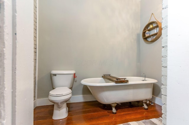 141 E 5th Ave, Lancaster, OH 43130 - bathroom with wood finished floors, a freestanding bath, toilet, and baseboards