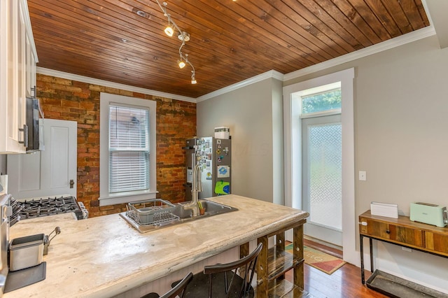 141 E 5th Ave, Lancaster, OH 43130 - dining space with crown molding, wooden ceiling, dark wood-type flooring, and brick wall