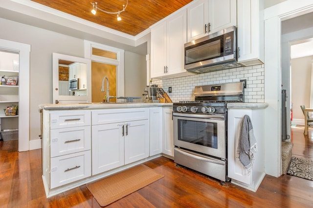 141 E 5th Ave, Lancaster, OH 43130 - kitchen with appliances with stainless steel finishes, a sink, a peninsula, wooden ceiling, and white cabinets