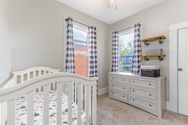 141 E 5th Ave, Lancaster, OH 43130 - bedroom featuring light carpet, a nursery area, baseboards, and ceiling fan