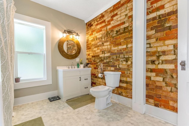 141 E 5th Ave, Lancaster, OH 43130 - bathroom with vanity, brick wall, toilet, baseboards, and tile patterned floors