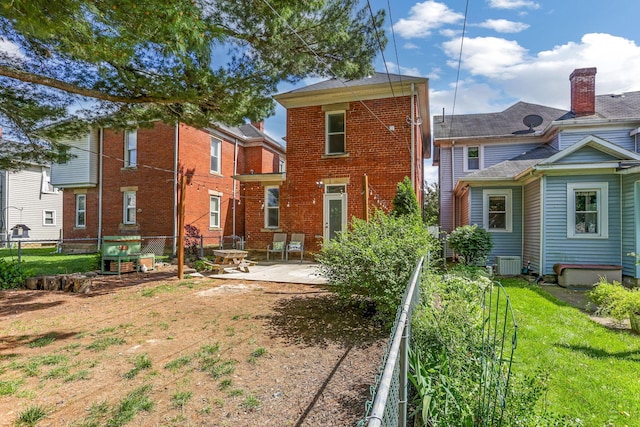 141 E 5th Ave, Lancaster, OH 43130 - rear view of property featuring a patio, brick siding, and central AC unit