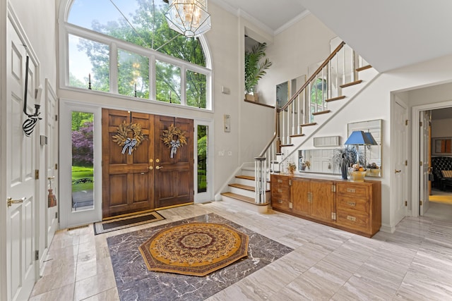 8039 Crossgate Ct S, Dublin, OH 43017 - foyer featuring a high ceiling, stairs, a chandelier, marble tiled floors, and baseboards