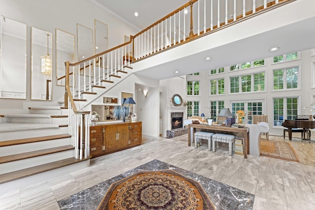 8039 Crossgate Ct S, Dublin, OH 43017 - stairway with a towering ceiling, a premium fireplace, crown molding, and recessed lighting