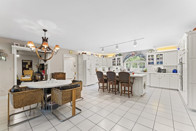 8039 Crossgate Ct S, Dublin, OH 43017 - dining area featuring a chandelier, light tile patterned flooring, and rail lighting