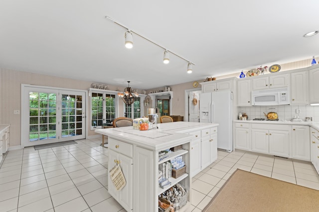 8039 Crossgate Ct S, Dublin, OH 43017 - kitchen featuring white appliances, light tile patterned floors, light countertops, and white cabinetry