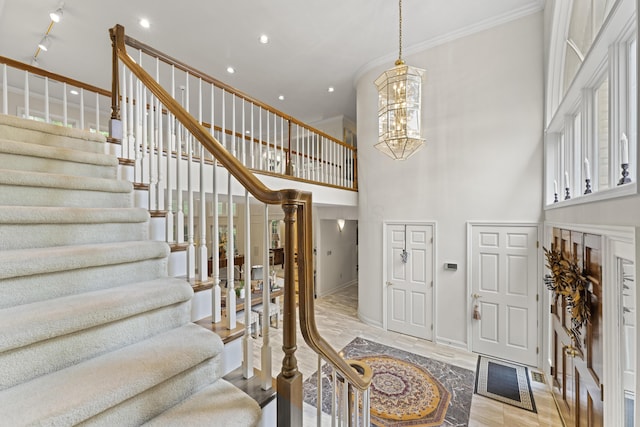 8039 Crossgate Ct S, Dublin, OH 43017 - foyer entrance featuring a chandelier, stairs, a towering ceiling, ornamental molding, and baseboards
