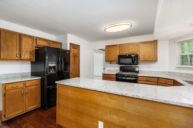 351 Northview Dr, Powell, OH 43065 - kitchen with black appliances, brown cabinets, dark wood-style floors, a peninsula, and light stone counters