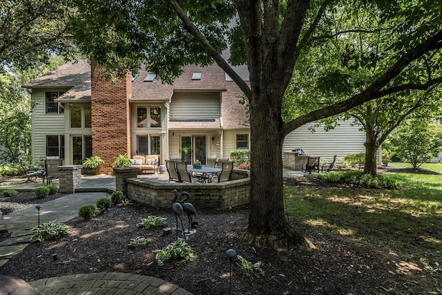 5714 Zetland Ct, Dublin, OH 43017 - rear view of property with a patio, roof with shingles, and a chimney