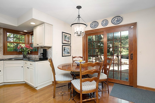 5714 Zetland Ct, Dublin, OH 43017 - dining area with a chandelier, light wood finished floors, and baseboards
