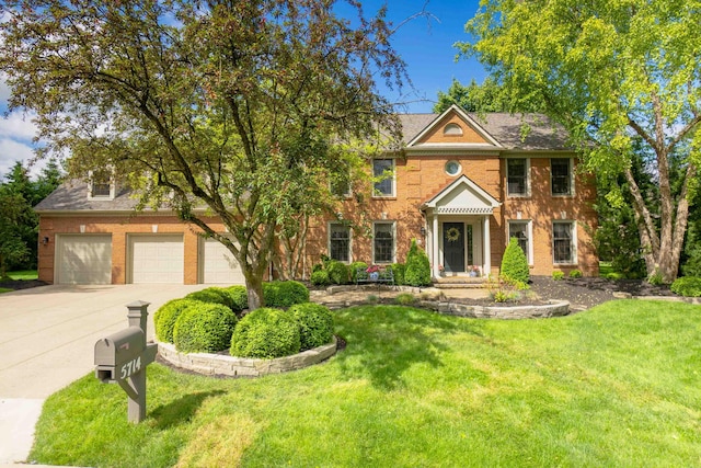 5714 Zetland Ct, Dublin, OH 43017 - colonial house featuring concrete driveway, brick siding, and a front yard