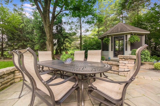 5714 Zetland Ct, Dublin, OH 43017 - view of patio featuring outdoor dining space, an outdoor structure, and view of wooded area