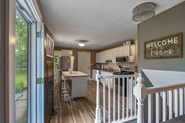 5250 Summit Rd SW, Pataskala, OH 43062 - kitchen with appliances with stainless steel finishes, white cabinets, backsplash, dark wood-type flooring, and a sink