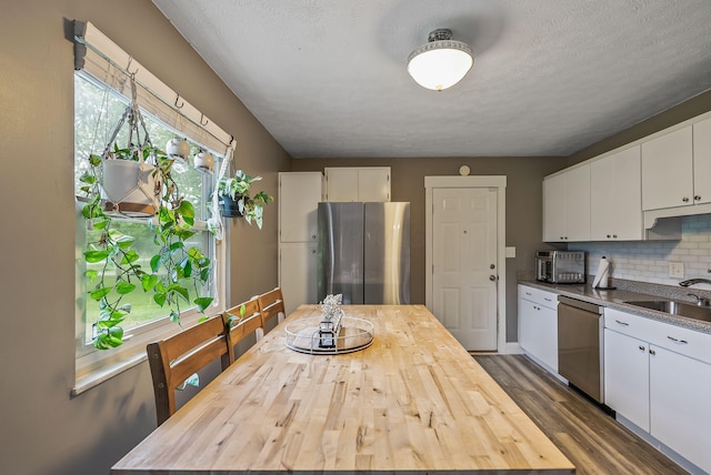 5250 Summit Rd SW, Pataskala, OH 43062 - kitchen featuring appliances with stainless steel finishes, wood counters, white cabinetry, dark wood-style flooring, and tasteful backsplash