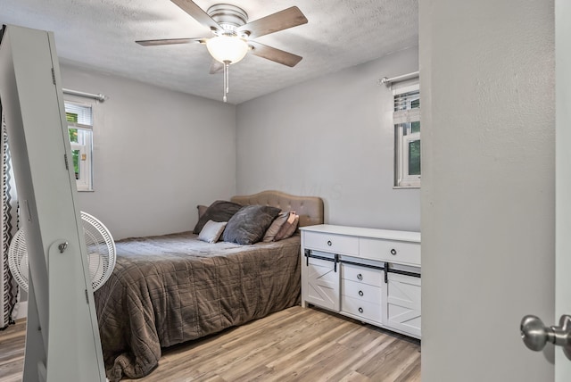 5250 Summit Rd SW, Pataskala, OH 43062 - bedroom featuring light wood-style floors, a textured ceiling, and ceiling fan