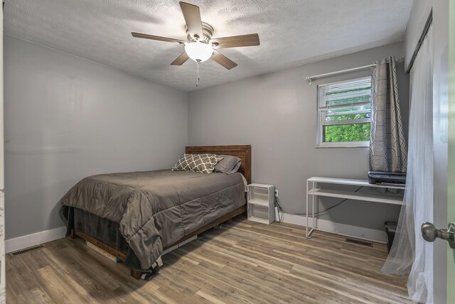 5250 Summit Rd SW, Pataskala, OH 43062 - bedroom with a textured ceiling, wood finished floors, baseboards, and a ceiling fan