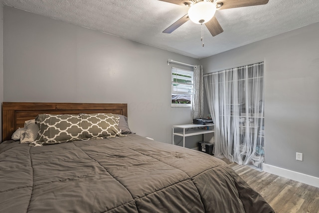 5250 Summit Rd SW, Pataskala, OH 43062 - bedroom featuring wood finished floors, a textured ceiling, baseboards, and a ceiling fan