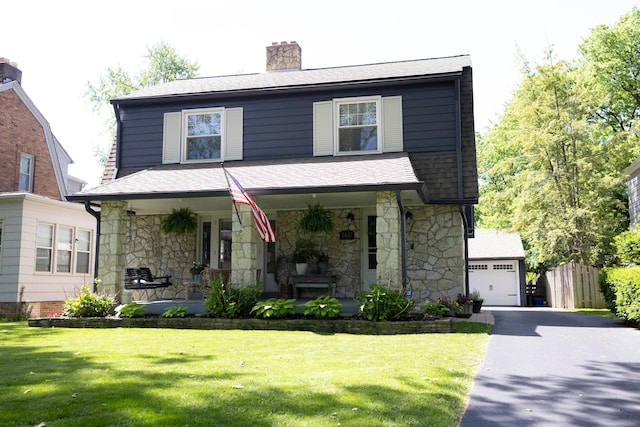 2443 Dale Ave, Columbus, OH 43209 - view of front of house with stone siding, covered porch, a chimney, roof with shingles, and driveway
