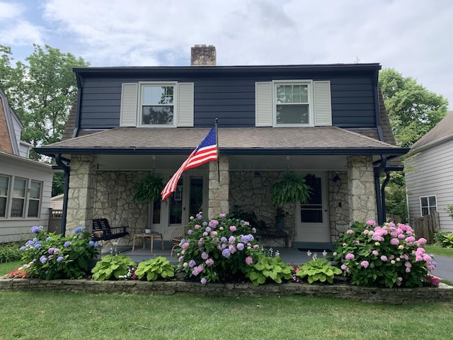 2443 Dale Ave, Columbus, OH 43209 - view of front of property featuring a porch, stone siding, a chimney, and a shingled roof