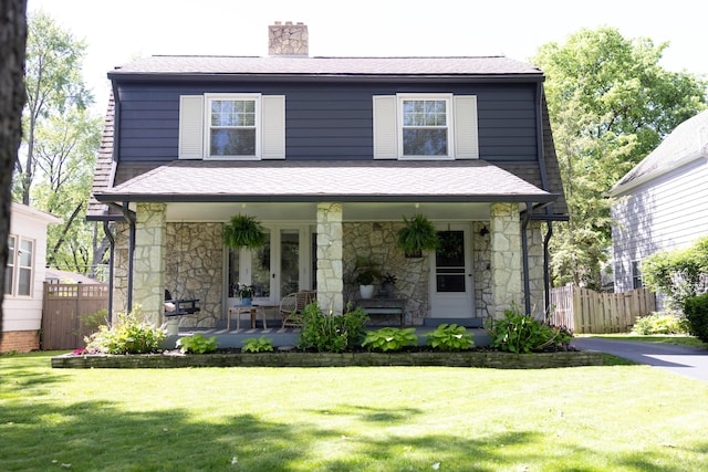 2443 Dale Ave, Columbus, OH 43209 - view of front of home with stone siding, a chimney, a porch, and a shingled roof