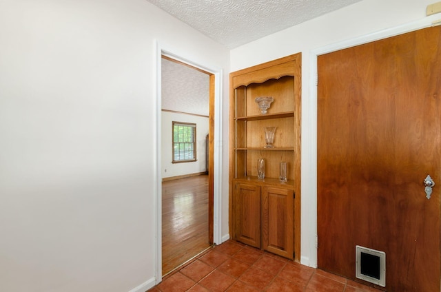 193 N Remington Rd, Columbus, OH 43209 - hall featuring baseboards, a textured ceiling, and tile patterned floors