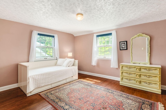 193 N Remington Rd, Columbus, OH 43209 - bedroom with multiple windows, wood finished floors, and a textured ceiling