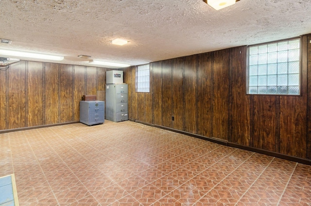 193 N Remington Rd, Columbus, OH 43209 - basement with light floors, wooden walls, and a textured ceiling
