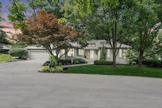 744 Old Oak Trce, Columbus, OH 43235 - view of front of home with driveway, stucco siding, a yard, and a garage
