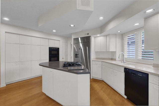 744 Old Oak Trce, Columbus, OH 43235 - kitchen featuring black appliances, a sink, light wood-style floors, white cabinets, and a kitchen island