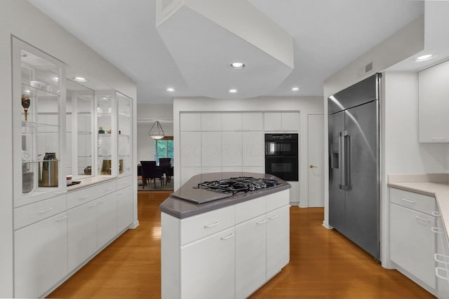 744 Old Oak Trce, Columbus, OH 43235 - kitchen featuring black appliances, light wood finished floors, a center island, white cabinets, and recessed lighting