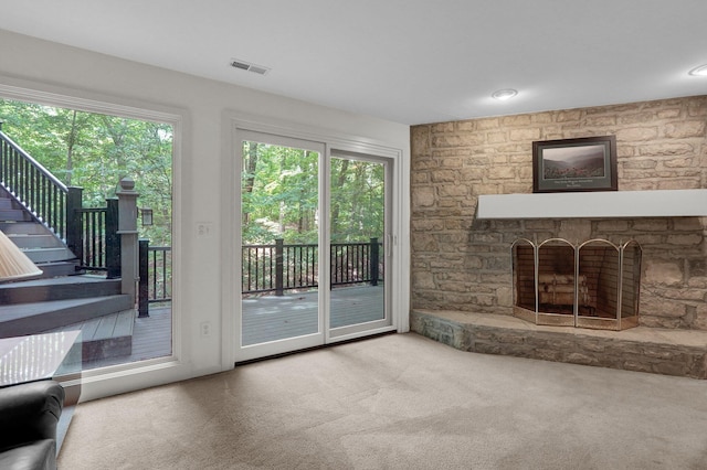 744 Old Oak Trce, Columbus, OH 43235 - unfurnished living room featuring a fireplace, carpet flooring, plenty of natural light, and stairs