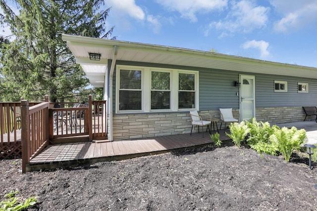 13441 Graham Rd SW, Pataskala, OH 43062 - rear view of house with stone siding and a wooden deck