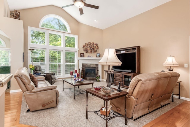 165 Tinley Park Cir, Delaware, OH 43015 - living area featuring a ceiling fan, wood finished floors, a tiled fireplace, and high vaulted ceiling