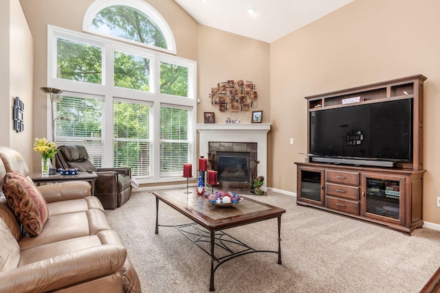 165 Tinley Park Cir, Delaware, OH 43015 - carpeted living area featuring a towering ceiling and a tile fireplace