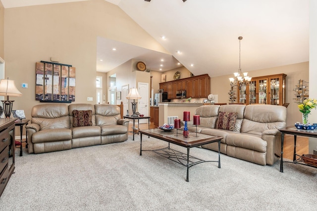 165 Tinley Park Cir, Delaware, OH 43015 - living room featuring light carpet, high vaulted ceiling, a chandelier, and recessed lighting