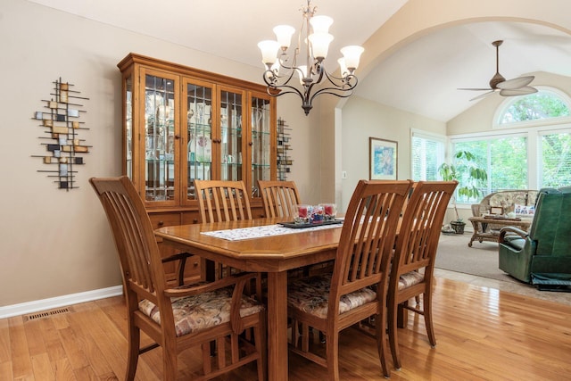 165 Tinley Park Cir, Delaware, OH 43015 - dining room with a ceiling fan, arched walkways, light wood-type flooring, vaulted ceiling, and a chandelier