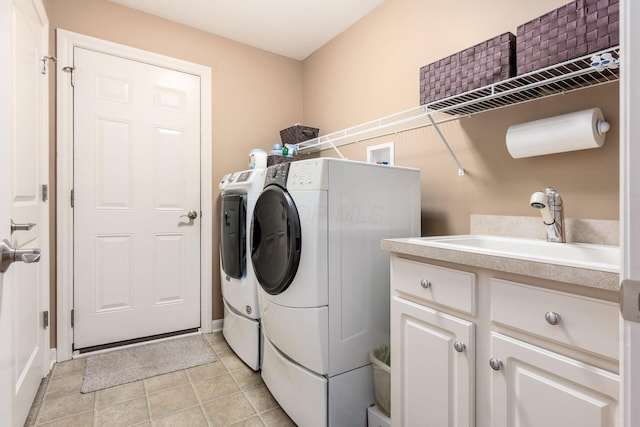 165 Tinley Park Cir, Delaware, OH 43015 - laundry room featuring washing machine and clothes dryer, light tile patterned floors, and cabinet space