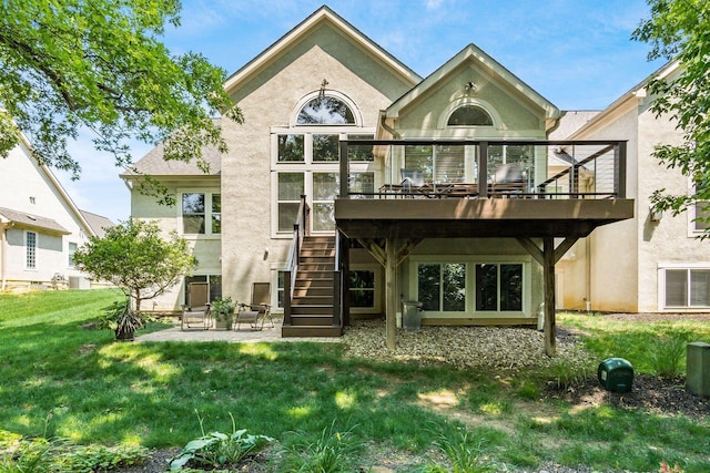 165 Tinley Park Cir, Delaware, OH 43015 - rear view of property featuring stucco siding, stairway, a yard, a wooden deck, and a patio area
