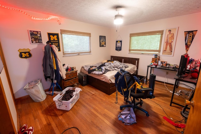 9442 Mitchell Dewitt Rd, Plain City, OH 43064 - bedroom with a textured ceiling, multiple windows, and wood finished floors