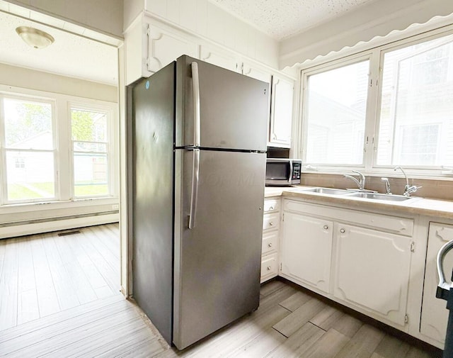 313 E Auburn Ave, Bellefontaine, OH 43311 - kitchen featuring appliances with stainless steel finishes, a sink, white cabinets, and a textured ceiling