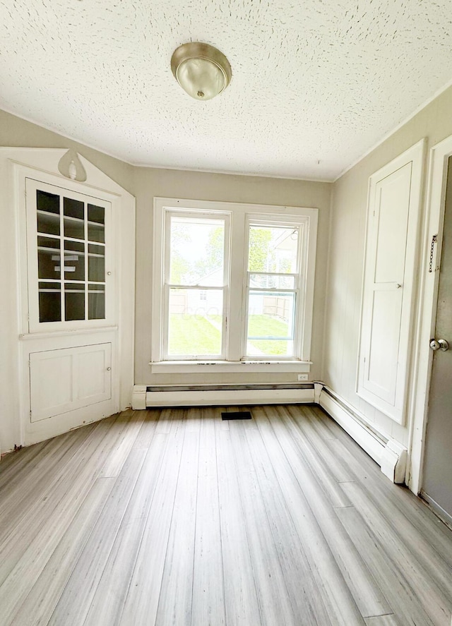 313 E Auburn Ave, Bellefontaine, OH 43311 - spare room with light wood-style floors, a textured ceiling, and a baseboard radiator