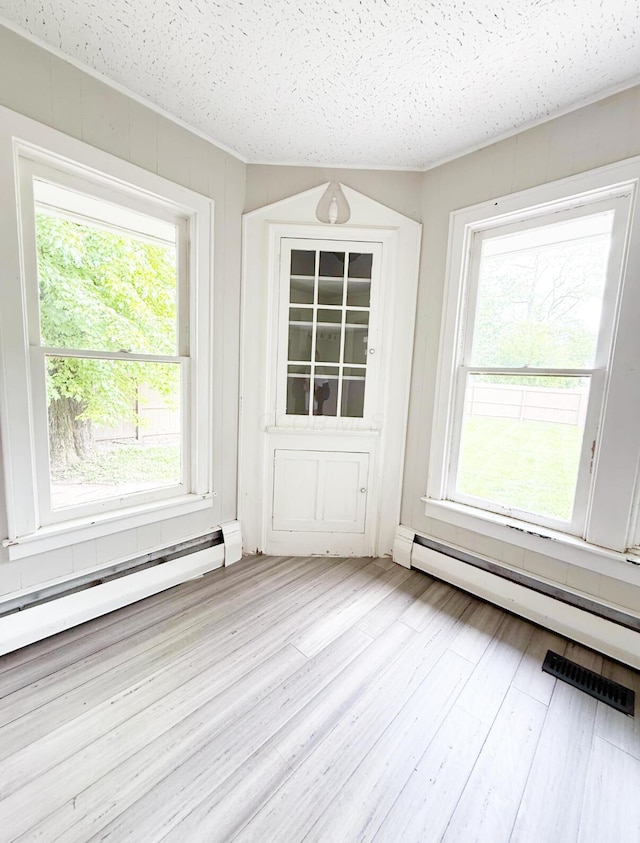 313 E Auburn Ave, Bellefontaine, OH 43311 - unfurnished sunroom featuring a baseboard radiator, a baseboard heating unit, and healthy amount of natural light
